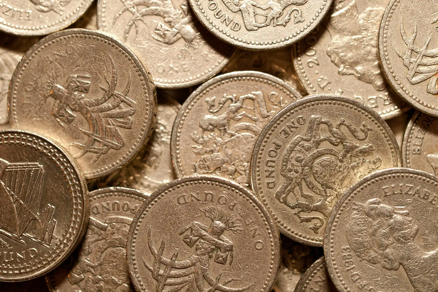 A close-up of a heap of British one pound coins