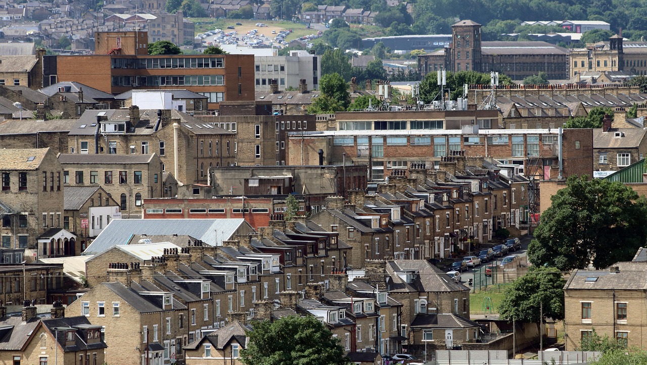 Terraced housing in Bradford with office and factory blocks rising in the background – vehicle‑secured loans in Bradford